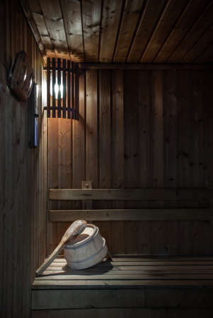 Wooden sauna interior room with traditional sauna accessories, relax in a hot sauna.の写真素材