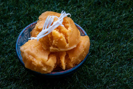 Toddy Palm Cake or Kanom Tarn is local Thai Dessert, sweet, soft and delicious. Made from ripen toddy palm, scraped coconut, and other ingredients, taste delicious, Oblique view from the top, copy space.の写真素材