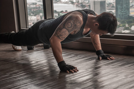 Bangkok, Thailand 06 Oct 2019 : Athletic man performs push-up exercises in the gym, Muscular and...