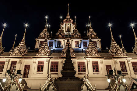 Bangkok, Thailand - 07 Nov. 2019 : Golden shining Loha Prasat (Metal Castle) lit up at night, a pyramid shaped Buddhist temple from 1846 for meditation in Wat Ratchanatdaram, Here It is the most tourist destination landmark in Phra Nakhon district.のeditorial素材