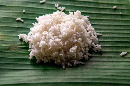 White rice is cooked rice by steaming or boiling on served on a banana leaf in Thai restaurant that is staple food in Thailandの写真素材