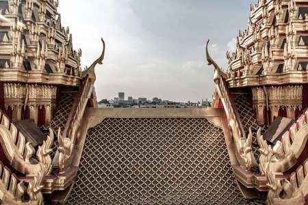 Bangkok, Thailand - Nov 23, 2019 : Symmetry view of Loha Prasat Metal Palace at Ratchanatdaram temple beyond the golden temple roof.のeditorial素材