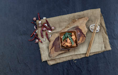 Thai Spicy food, Spicy Stir Fried Deep Fish Fillet with Herbs vegetables  in wooden bowl : in Thai language calledの写真素材