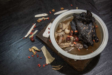 Chinese traditional nourishing health stew, stewed black bone chicken, Chinese black chicken soup, This soup very famous among chinese food and asian food as a healthy soup, food as medicine.  Oblique view from the top.の写真素材