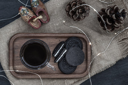 Cup of coffee with chocolate chip cookies on wooden tray. Concept for a tasty snack, Selective...