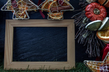 Christmas decoration, Brown natural pine cones and variety of fruits with Empty wooden frame for...