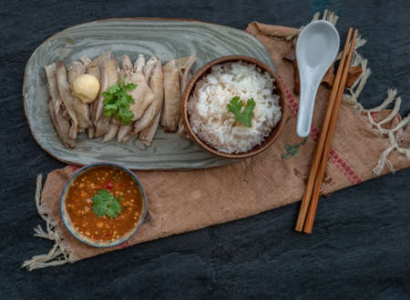 Asian food style marinated steamed chicken (Betong Chickken) with Rice and sauce on ceramic plate. Top view.の写真素材