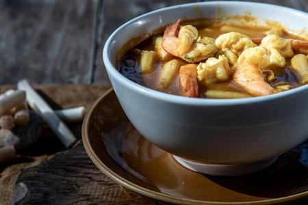 Sour soup with lotus stem and shrimps (kaeng som koong with lotus stem), Traditional Thai food,...