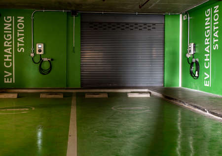 Bangkok, Thailand - Jan 04, 2020 : Front view of electric vehicle charging station and battery on the wall in a building parking lot, Fast battery exchange solution.のeditorial素材