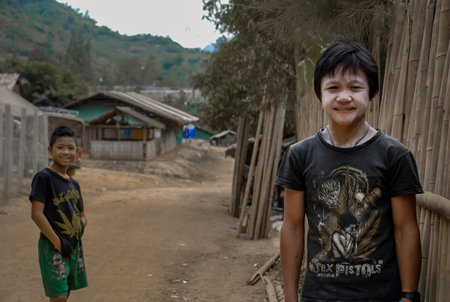 Mae Hong Son, Thailand - Jan 22, 2010 : Refugee people, Two refugee boys in temporary shelter at refugee camp in Thailand, Selective focus.のeditorial素材