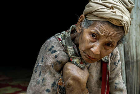 Mae Hong Son, Thailand - Jan 22, 2010 : Refugee people, Old refugee woman in temporary shelter at refugee camp in Thailand, Selective focus.のeditorial素材