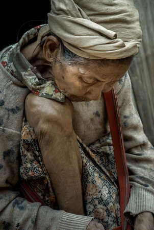 Mae Hong Son, Thailand - Jan 22, 2010 : Refugee people, Old refugee woman in temporary shelter at refugee camp in Thailand, Selective focus.のeditorial素材