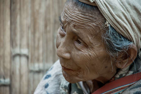 Mae Hong Son, Thailand - Jan 22, 2010 : Refugee people, Old refugee woman in temporary shelter at refugee camp in Thailand, copy space, Selective focus.のeditorial素材