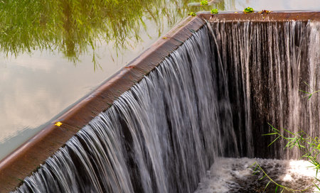 Turbid water in the check dam overflows into the spillway, Man-made Water falling in Tambon Khok...