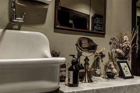 Bangkok, Thailand - Nov 23, 2019 : Vintage bathroom interior with wash white Basin, Vanity, Hand soap bottle, Mirror and dried flowers, Selective focus.のeditorial素材
