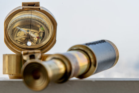 Vintage Binocular and Antique bronze emblem compass (Old compass) with Sky Background. Journey...