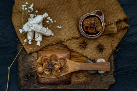 Brown cane sugar cube on wooden ladle and sackcloth. Selective focus. Top view.の写真素材