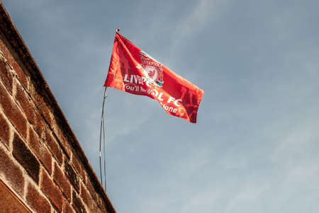 Liverpool - England - April 13, 2019: Liverpool F.C. Flag waving with the blue sky background.のeditorial素材