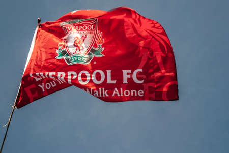 Liverpool - England - April 13, 2019: Liverpool F.C. Flag waving with the blue sky background.のeditorial素材
