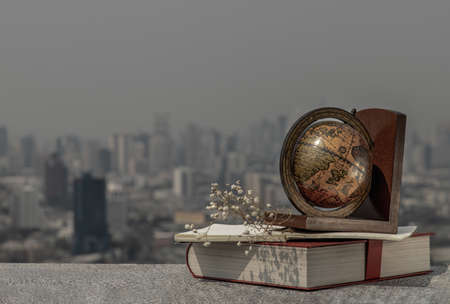 Journey and Learning concept background. Globe and stack of books with a sky background. Copy space.の写真素材