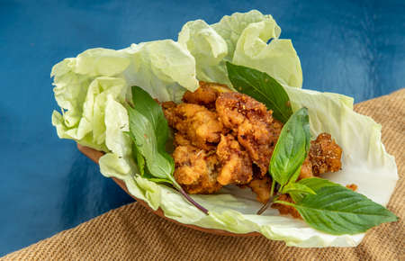 Thai cuisine, Deep fried spicy minced chicken with spicy thai herbs Served on Chinese cabbage. Selective focus.の写真素材