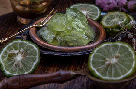 Traditional Thai dessert call candied kaffir lime on wooden background. Summer time, Selective Focus.の写真素材