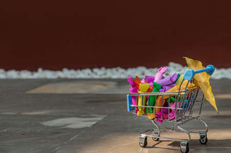 Colorful Jelly toffee in shopping cart on tiles floor. Giving happiness, Happy holidays, Selective focus.の写真素材