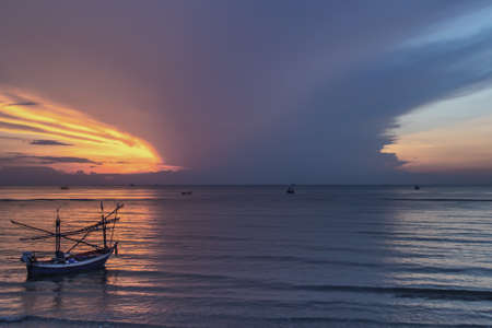 Thai fishing boat used as a vehicle for finding fish in the during beautiful twilight in the sea. No focus, specifically.の写真素材