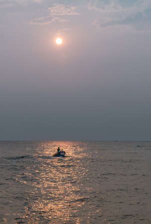 The fisherman and wooden fishing boat used as a vehicle for finding fish in the sea. Selective focus.の写真素材