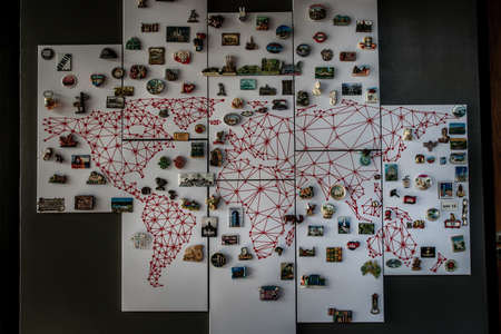 Bangkok, Thailand - 15 Dec 2019 : Refrigerator magnets from different cities of the world on whiteboard in loft style home, Popular souvenir and collectible objects.のeditorial素材