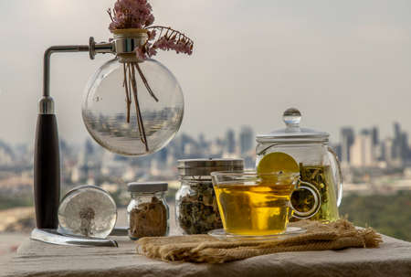 Refreshing and enjoy with A cup of lemongrass pandan tea served with brown sugar In the afternoon on beautiful city view. Thai herbal plant and healthy drinks concept. Selective focus, Copy space.の写真素材