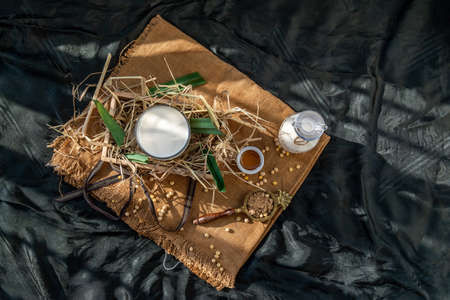 Soy products : A glass of Homemade soy milk and grains (soybeans) in wooden box Served with brown sugar and honey with lighting in the morning. Alternative milk concept, Top view, Selective focus, Copy space.の写真素材