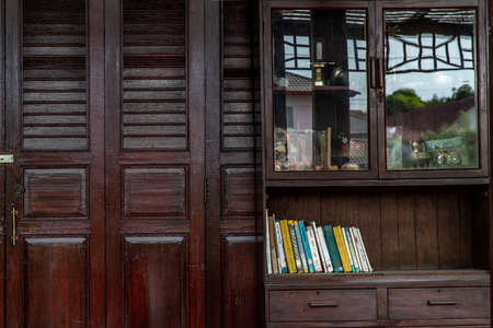 Bangkok, Thailand - 15 Dec 2019 : Interior design in Thai style with Wooden dresser classic and Books, Thai Style architecture.の写真素材
