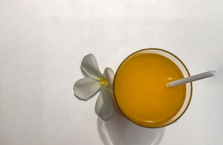 A glass of fresh orange juice for a refreshment on silver background. leisure activity.の写真素材