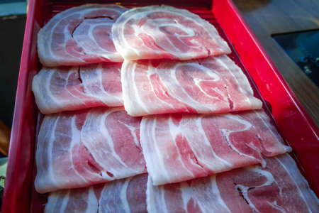 Freshness Beef pork slices in tray for Japanese Sukiyaki or Shabu-shabu. Hot pot foods restaurant menu concept. Selective focus.の写真素材