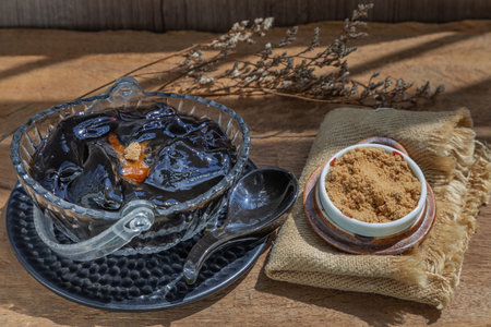 Black grass jelly (Mesona chinensis) Dessert herbal gelatin or jelly black with ice and brown sugar...