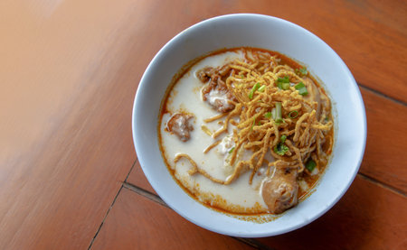 Traditional Khao Soi Recipe, Thai Northern Style Curried Noodle Soup with Chicken in white bowl....