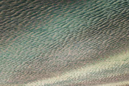 Abstract images of geometric shapes on buildings with repeating structure and reflected sky.の写真素材