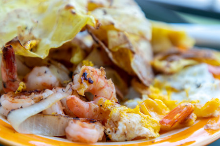 Breakfast with Omelet, Baked Shrimp, Onion and Deep fried Dumplings. Top view, Selective focus.の写真素材
