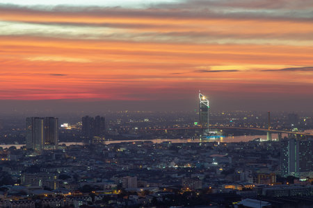 Bangkok, thailand - Dec 23, 2020 : Aerial view of Bangkok city Overlooking Skyscrapers and the Bridge crosses the Chao Phraya river with bright glowing lights at dusk. No focus, specifically.のeditorial素材