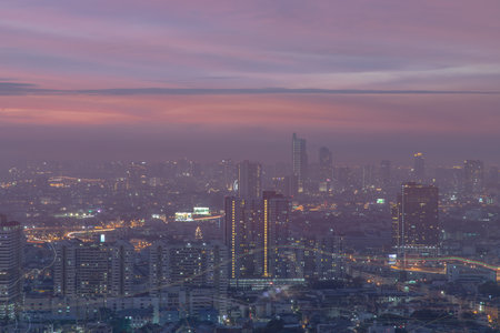 Bangkok, thailand - Dec 23, 2020 : Aerial view of Bangkok city Overlooking Skyscrapers and the Bridge crosses the Chao Phraya river with bright glowing lights at dusk. No focus, specifically.のeditorial素材
