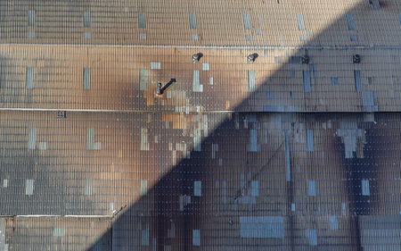 Construction Worker Welding soldering metal girders and Sparks in a Structure high above at the Construction site. Selective focus.の写真素材