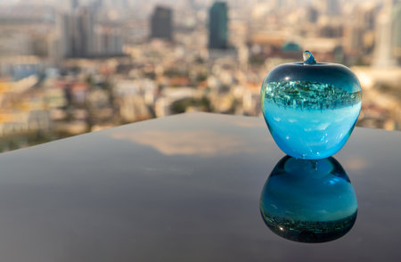 Glass or Crystal blue apple and reflective surface on blue water background. Copy space, Selective focus.の写真素材