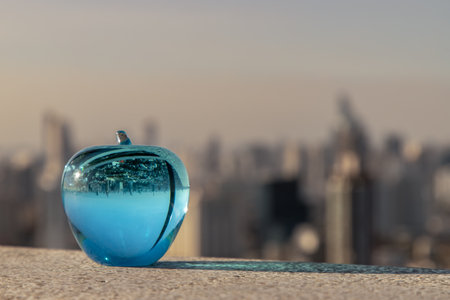Glass or Crystal blue apple and reflective surface on blue water background. Copy space, Selective focus.の写真素材