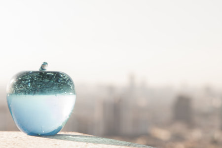 Glass or Crystal blue apple and reflective surface on blue water background. Copy space, Selective focus.の写真素材