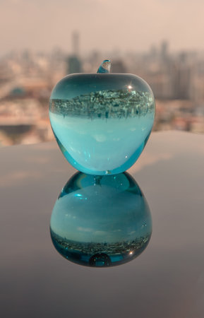 Glass or Crystal blue apple and reflective surface on blue water background. Copy space, Selective...