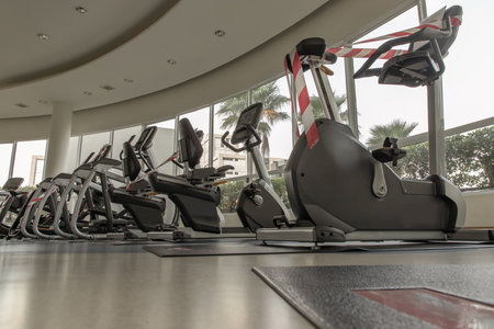 Bangkok, Thailand - Jan 28, 2021 : New normal concept and physical distancing people exercise on Training exercise bikes in fitness and keep spaced to prevent from disease outbreak. Selective focus.のeditorial素材