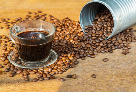 Coffee beans Pouring from cans roating around on the wooden background with copyspace for your text. Alternative coffee for living life, Coffee style, Selective focus.の写真素材