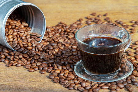 Coffee beans Pouring from cans roating around on the wooden background with copyspace for your text....