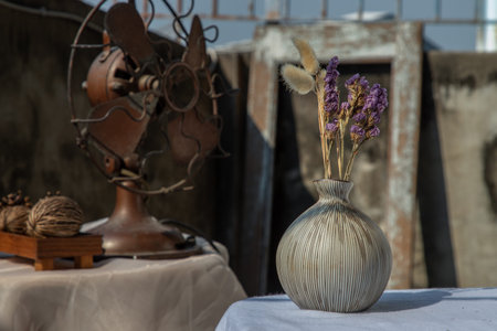 Small  yellow ceramic vases with bouquet of flowers in woven basket. Home decor, Selective focus.